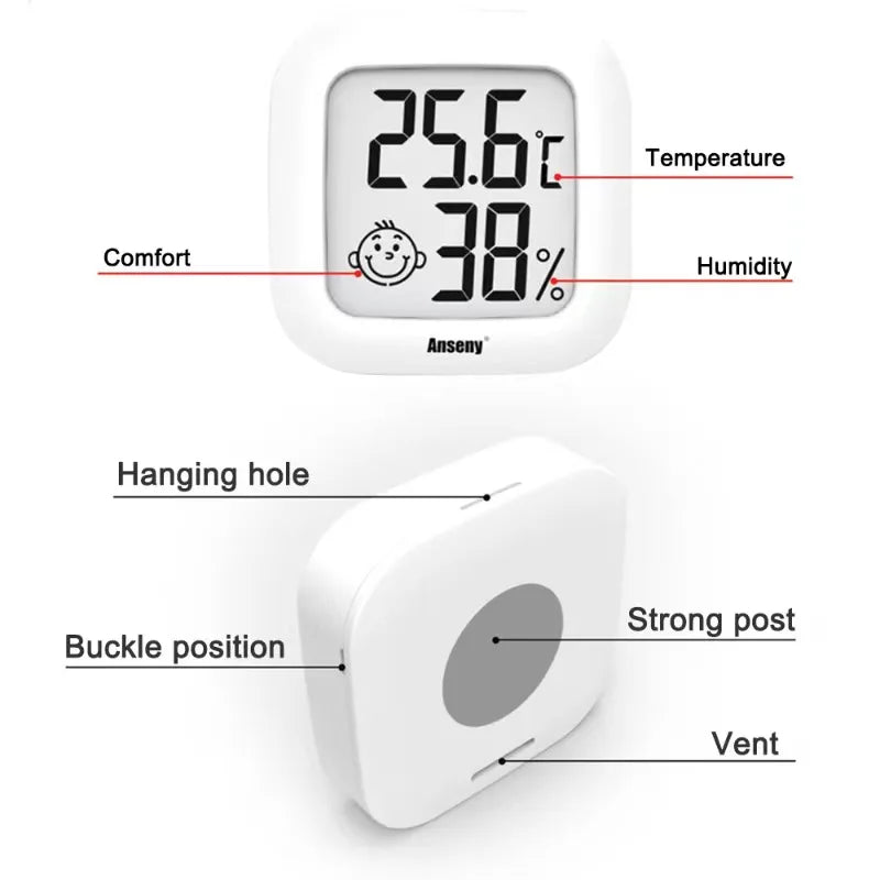 A white compact digital thermometer and hygrometer displaying 25.6°C and 38% humidity, with labels for comfort, temperature, 