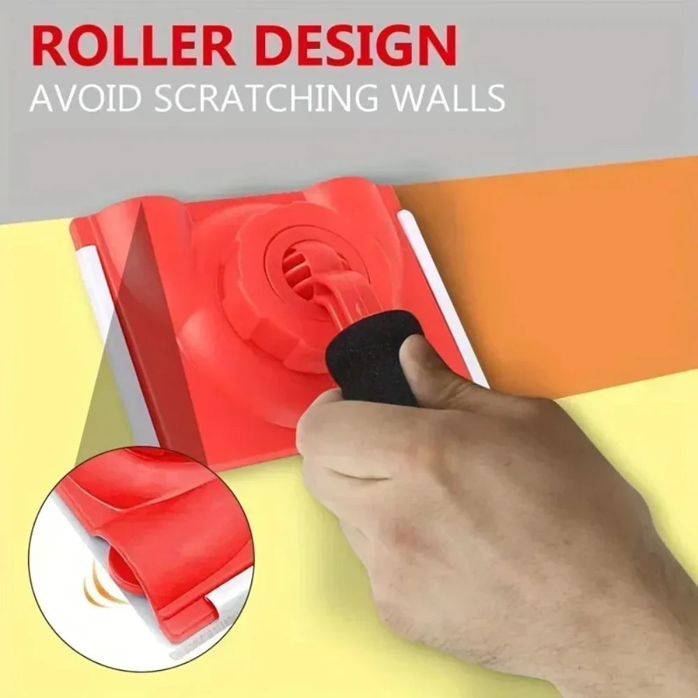 A hand is using a red roller design tool to trim paint edges and corners on a wall.