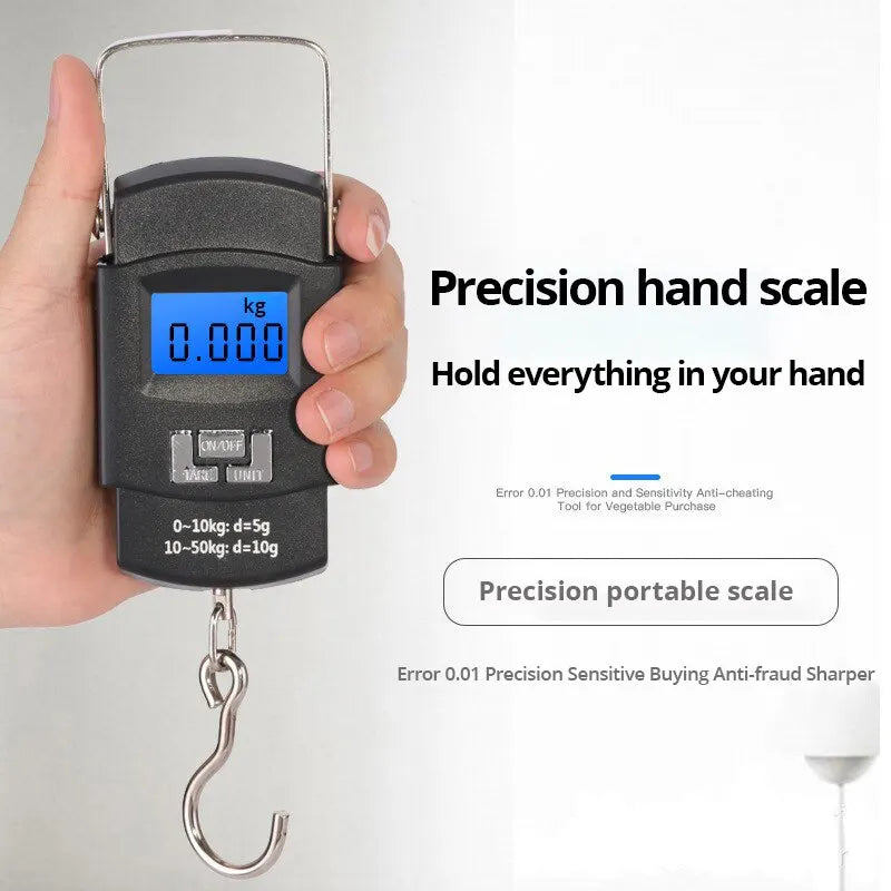 A hand holding a black precision portable scale with a hook, demonstrating its use for weighing items.