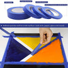 Rolls of blue painter's masking tape demonstrating its adhesive properties on various surfaces like wood, glass, and paper.