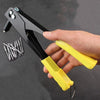A hand is holding a black heavy duty hand rivet gun kit with a yellow handle and rivets.