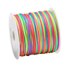 A spool of rainbow colored elastic beading cord with a white plastic spool.