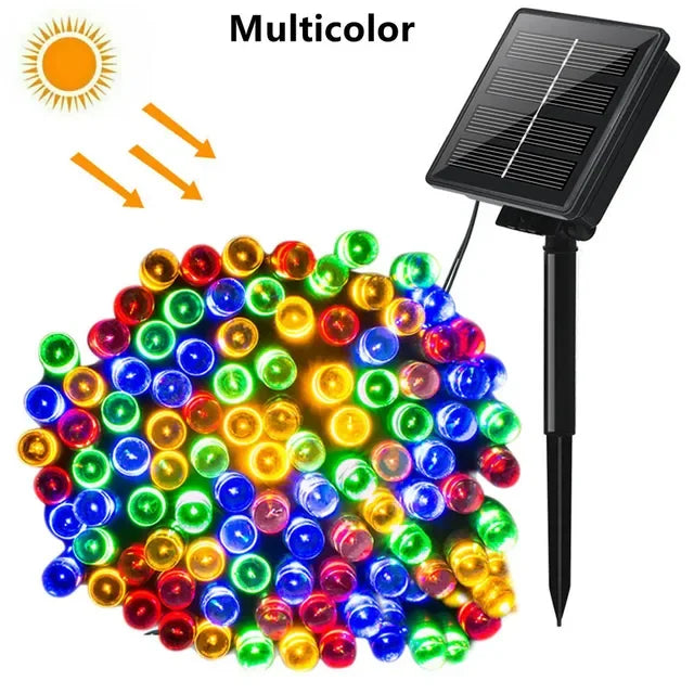 A cluster of multicolor solar powered outdoor LED string lights with a solar panel attached.