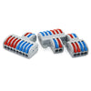 A set of gray electrical push-in connectors with red and blue insulation wires.