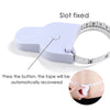 A white slot fixed tape measure is shown with a hand automatically recovering the tape.