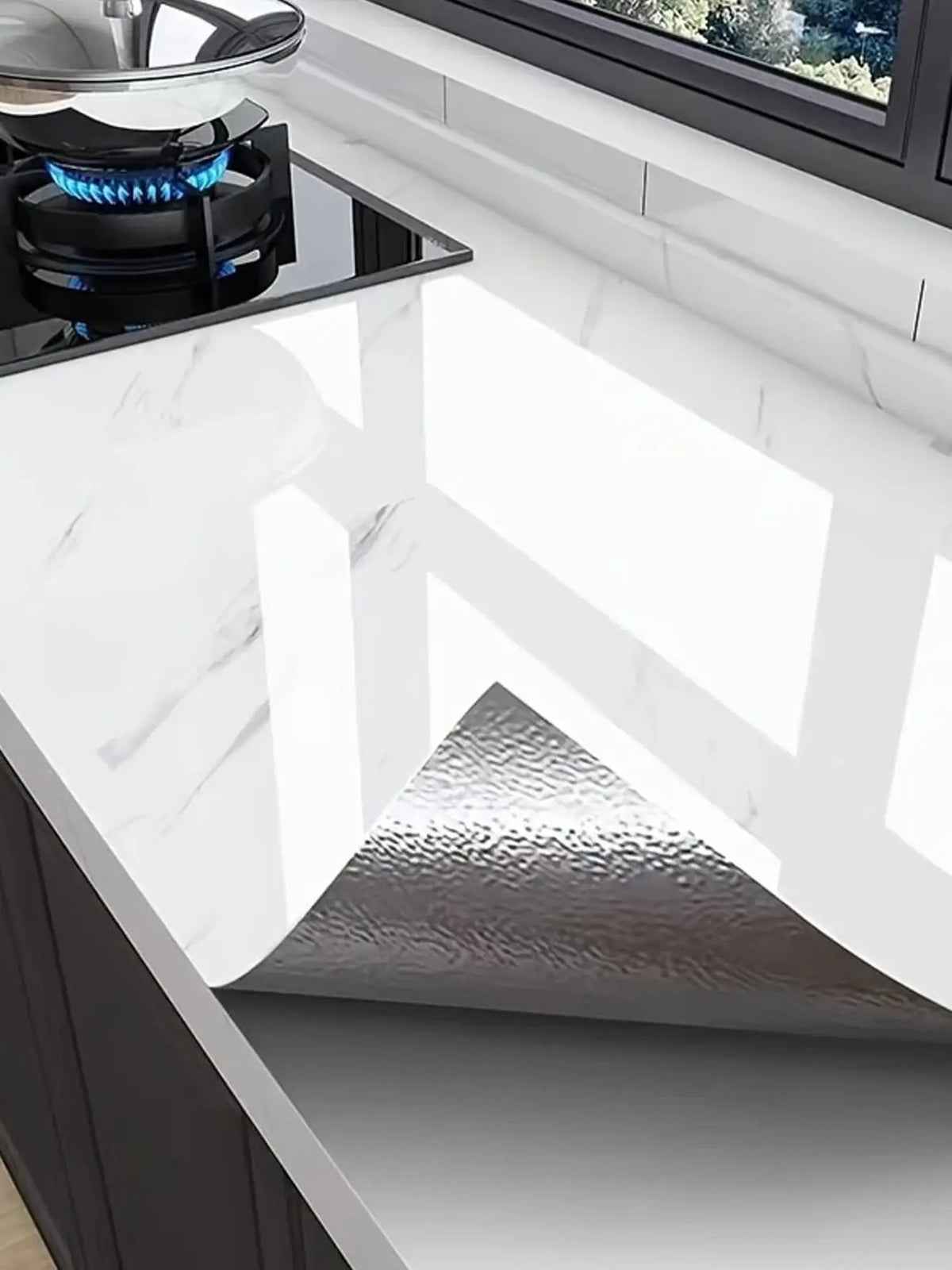 A close-up view of a marble self-adhesive waterproof contact paper installed on a dark cabinet surface.
