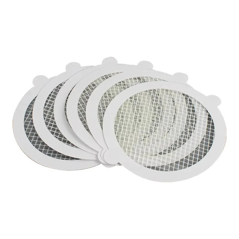 A stack of white reusable mesh strainers for bathroom drains.